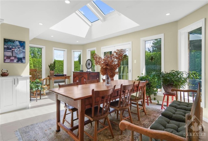 The gorgeous sun room and dining area with its skylight lends itself beautifully to family gatherings and informal dining.