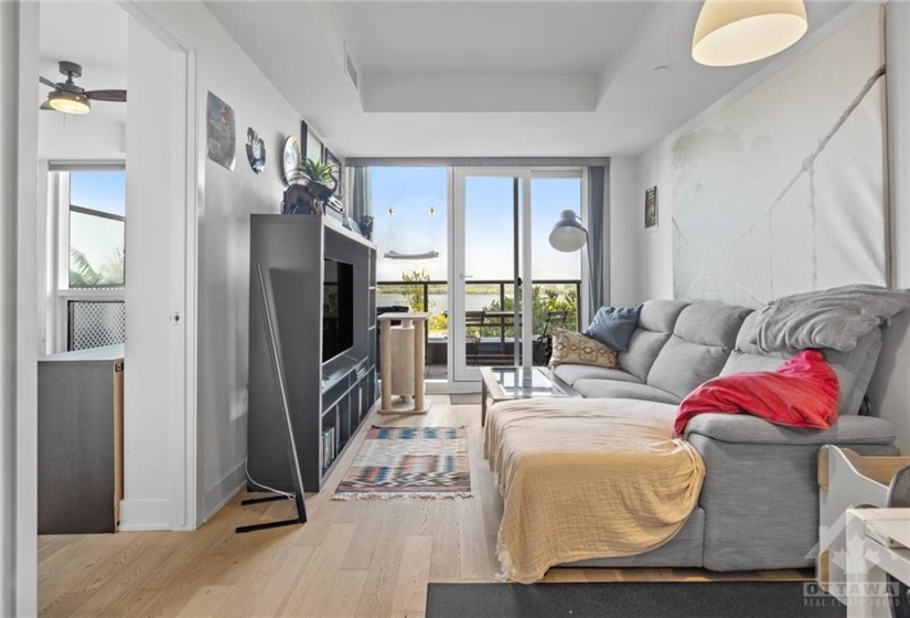 living area and door to bedroom on left, balcony at the front