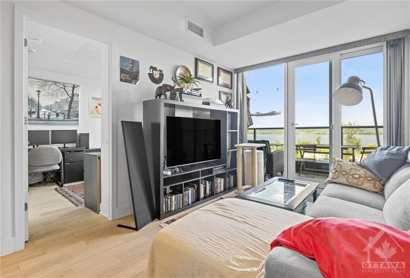 living area and door to bedroom and balcony