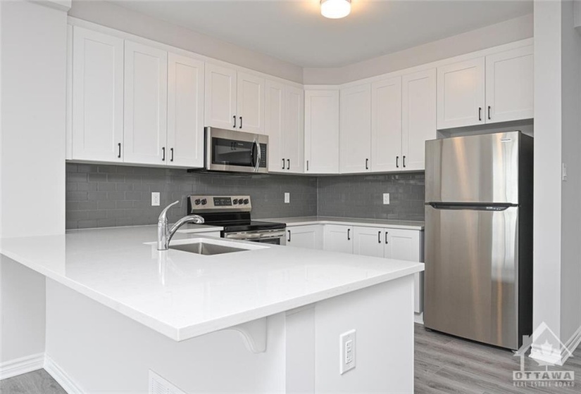 Kitchen - upgraded countertops, backsplash and S/S appliances