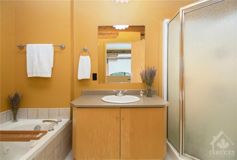 Second floor bathroom with large soaker tub and walk in shower