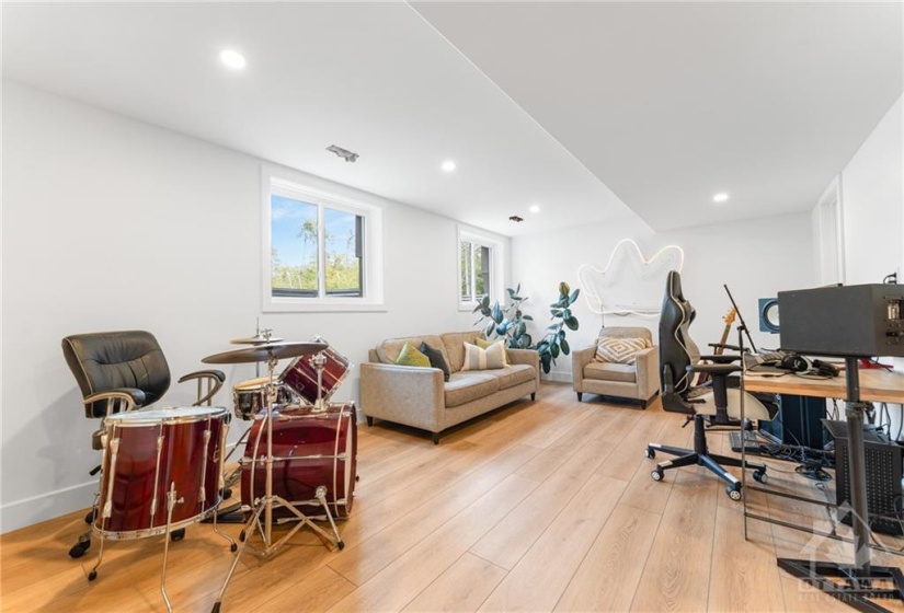 Fully Finished Basement w/Wide Plank Light Vinyl throughout Family Room w/Pot Lights