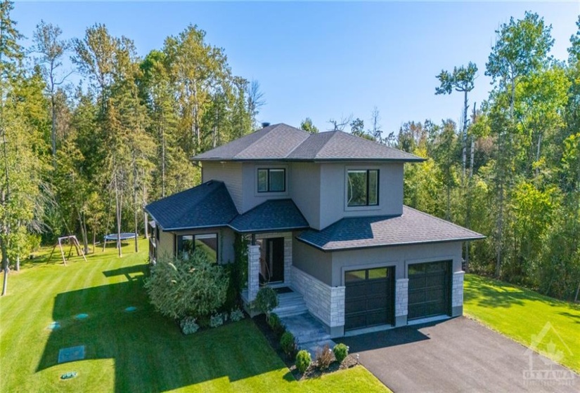 Beautifully Manicured Gardens w/Lg Windows w/Modern Black Frames, nicely set back from the road w/Irrigation system throughout the exterior