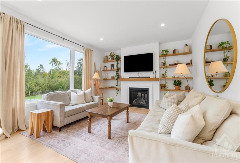 Spacious Living Room w/Pot Lights, Gas Fireplace w/Custom Wood Mantle & Wood Shelving