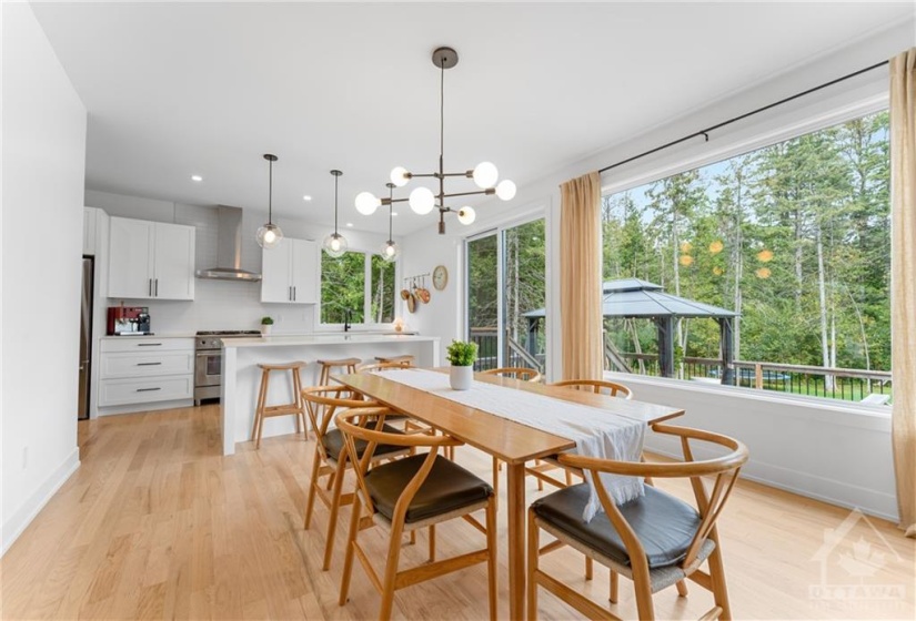 Spacious Dining Room is open to the Kitchen w/Patio Doors Leading to the Great Size Deck w/Gazebo, perfect for entertaining