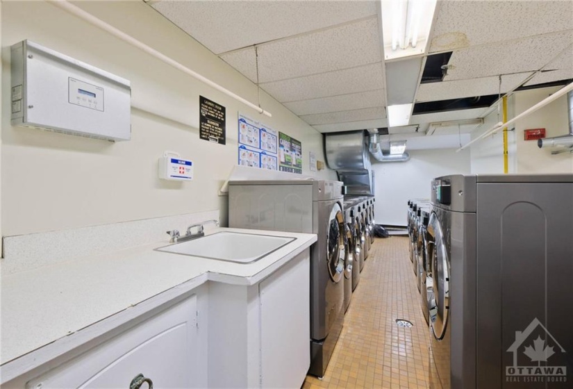 Laundry room with large washer and dryers.