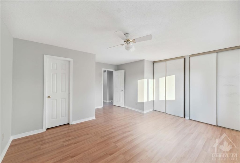 Primary bedroom with his and her closets and ensuite entrance.