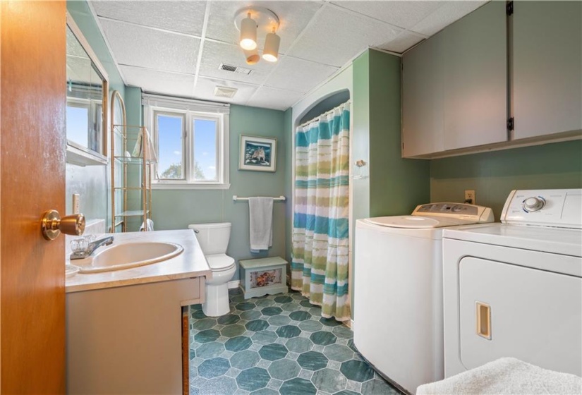 Second bathroom and laundry with oversized shower and new quality vinyl flooring