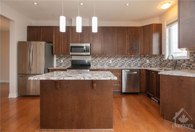 Granite countertops in the Kitchen with island & pot drawers