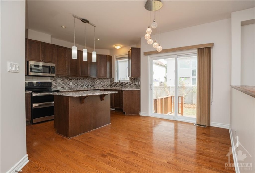 Eat-in kitchen with patio doors to large backyard