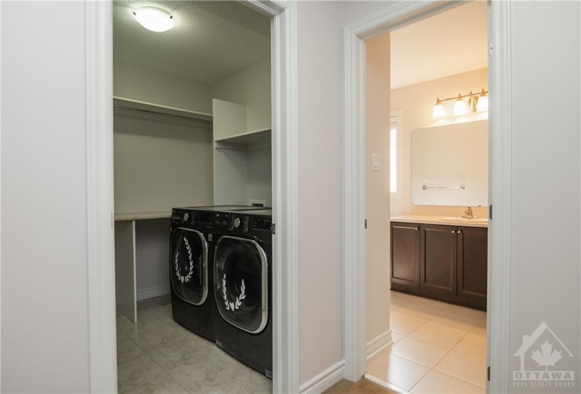 2nd Floor laundry with room for hanging plus a wall of storage behind the door