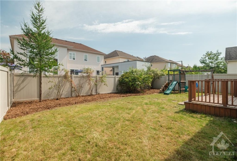 Wide backyard with play structure