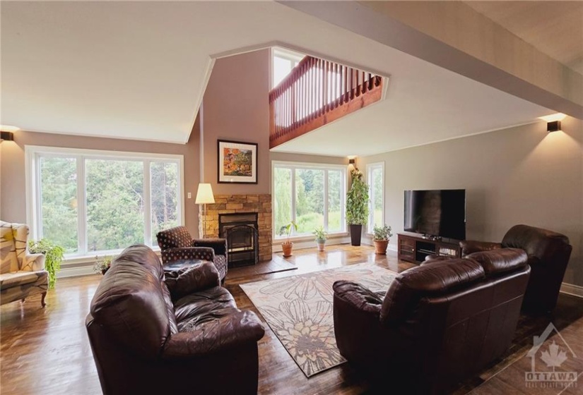 Primary Residence Living Room with wood-burning fireplace & refinished hardwood floors