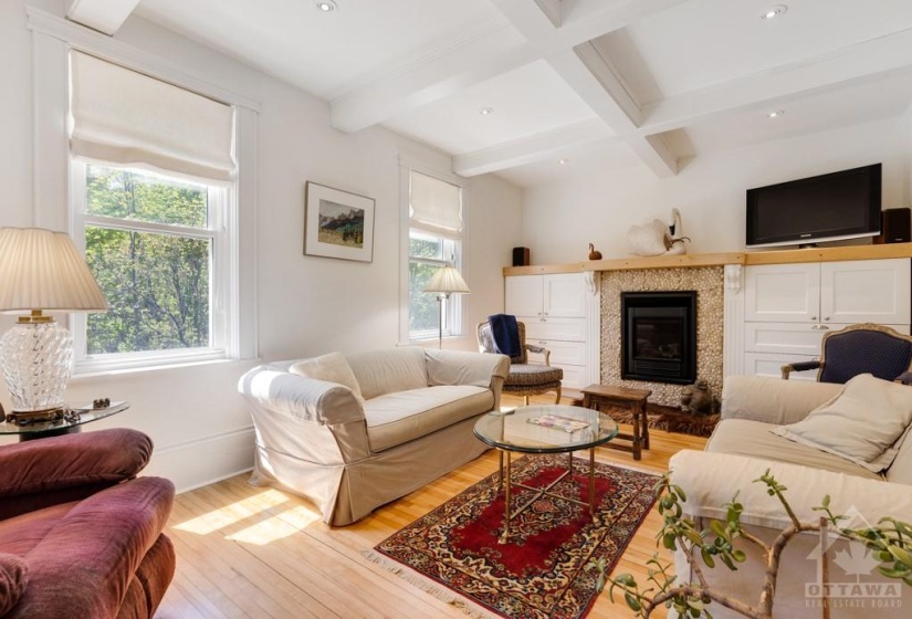 Living room with built-ins around propane fireplace