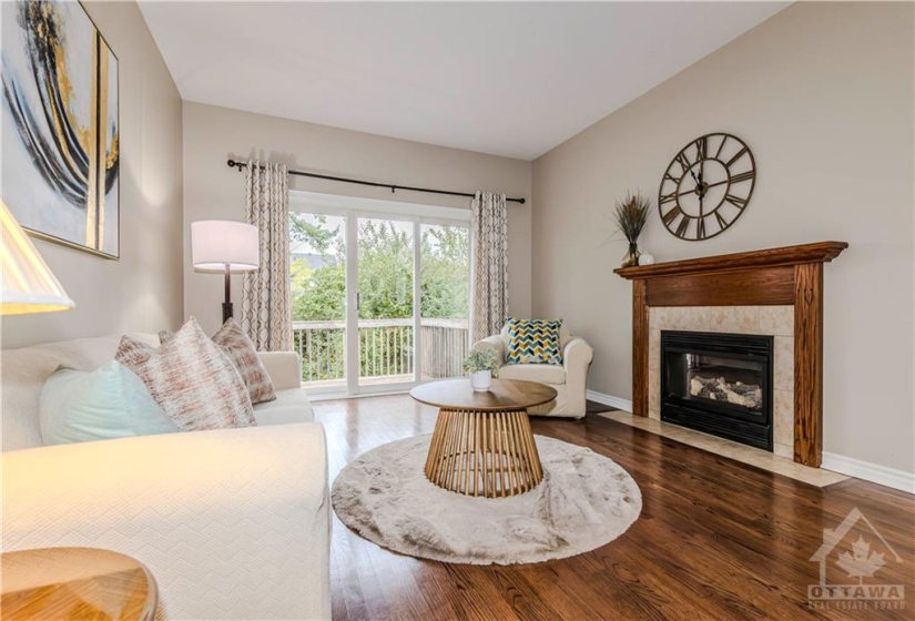 family room with a gas fireplace & access to the backyard