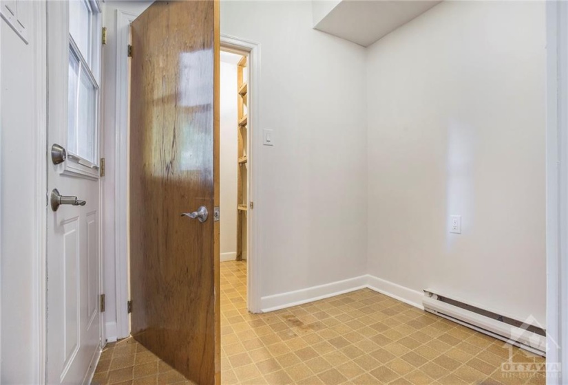 Mudroom entrance with door to large stroage/cloak room