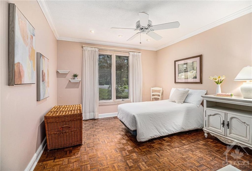 Secondary bedroom overlooks the expansive frontage of the home with mature trees