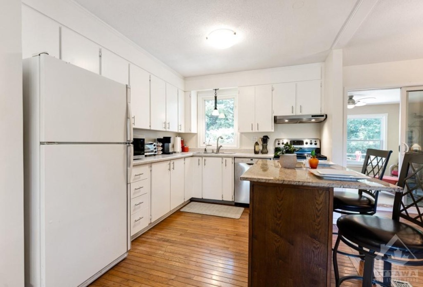 White bright kitchen with convenient island-breakfast bar