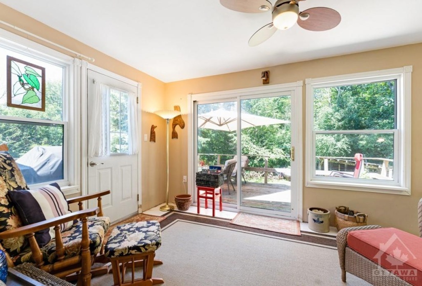 Sunroom has door and patio doors to deck