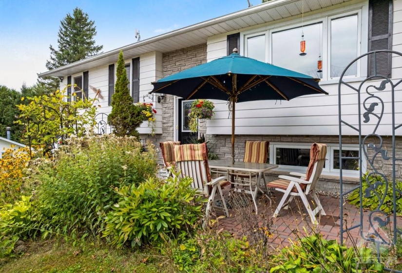 Lovely landscaped front with patio for lounging