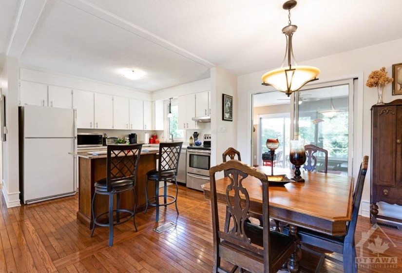 Dining room patio doors to sunroom with access to deck