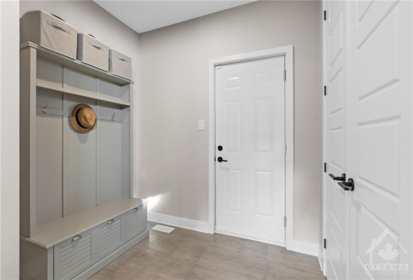 Mud room w/ inside access to garage & includes double door closet.