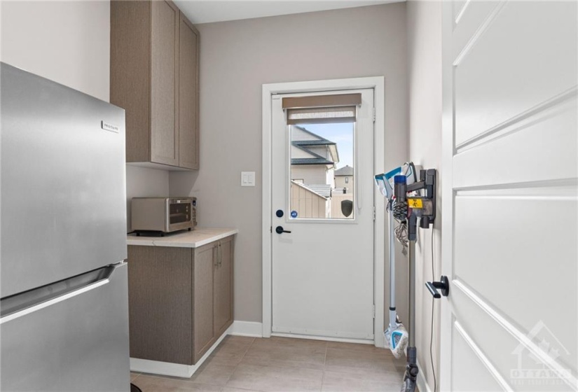 Butler's pantry w/ access to the backyard- great for storage and additional appliances.