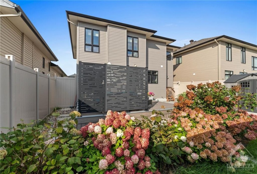 Fully landscaped garden, stepping stones and additional privacy wall along the deck edges.