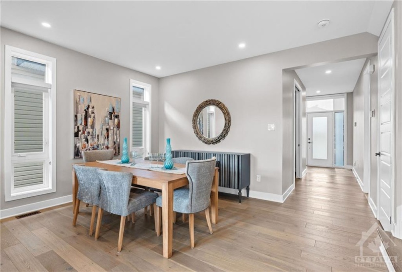 Dining room- Pot lights above and windows for natural light. Custom Blinds!