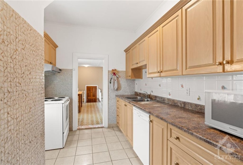 Spacious kitchen w/ tiled floors and tons of storage space throughout.