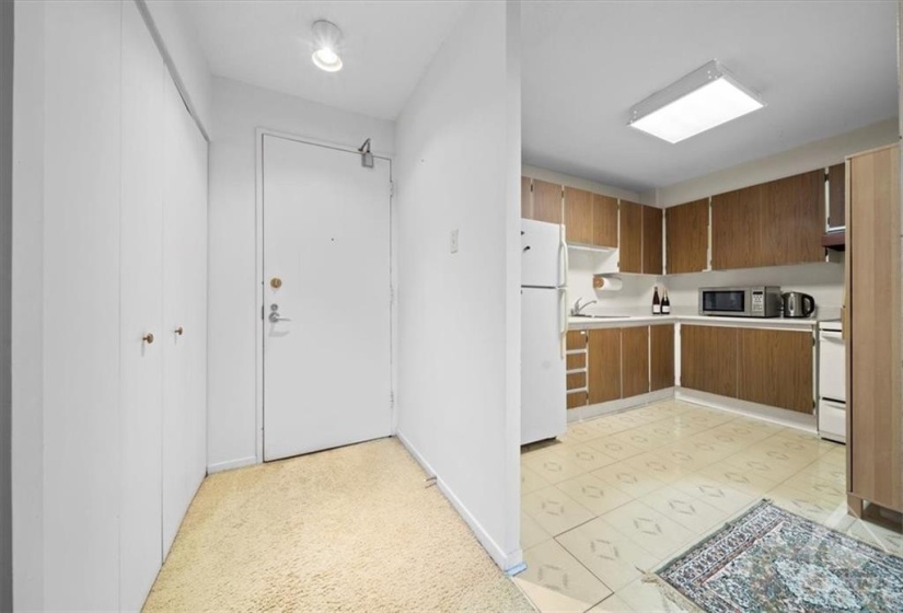 Spacious foyer opens to the kitchen on one side...