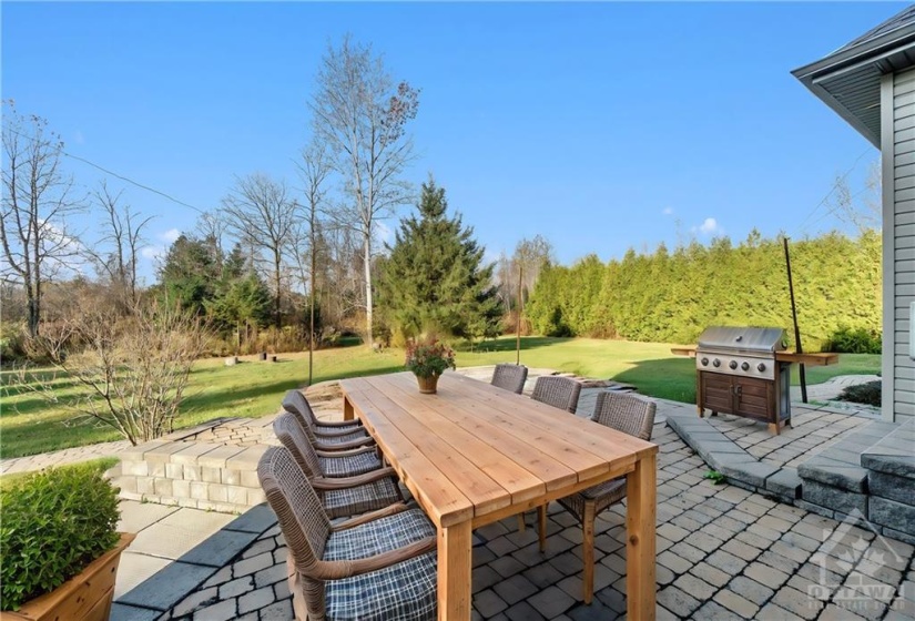 Step outside to enjoy the expansive patio, ideal for outdoor gatherings, and take in the natural beauty that surrounds you.