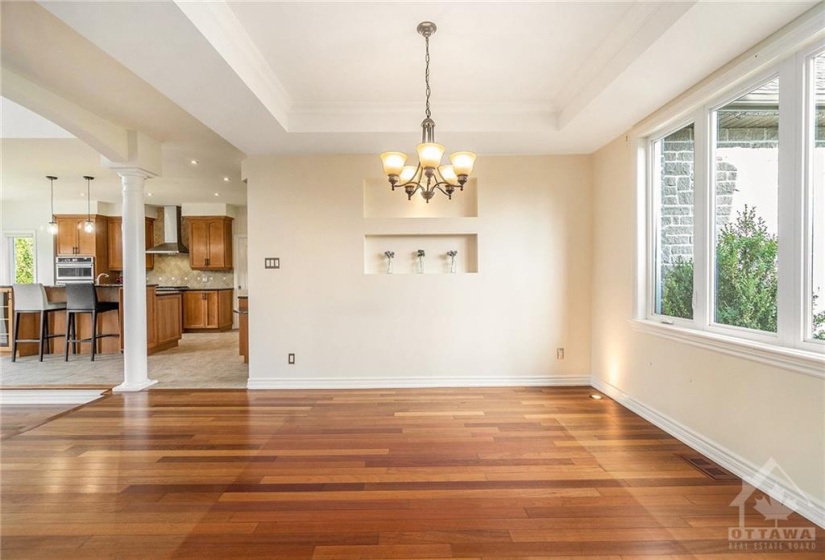 The dining room enhances the ambiance with its stylish ceiling detail.