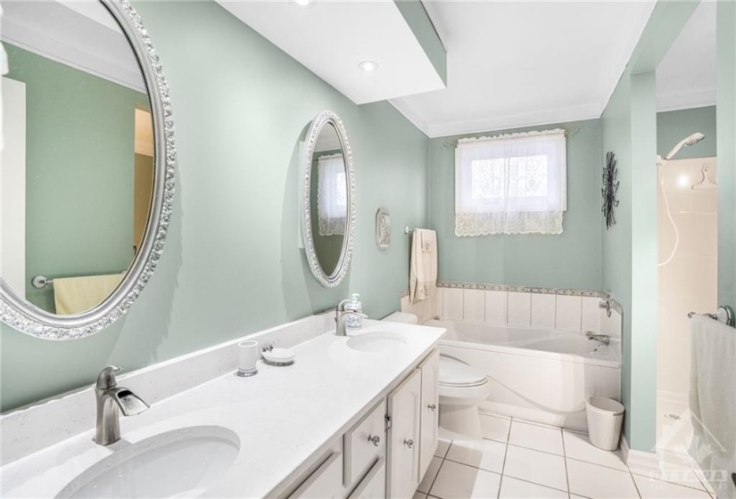 Main 5 pieces remodeled bathroom with double sink, tile flooring and the Sellers are in the process of getting a new glass shower installed.