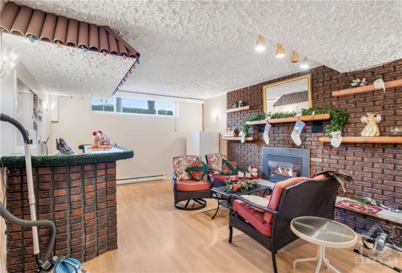 Huge family room with second gas fireplace and laminate flooring.