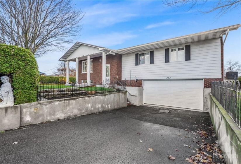 Pictured from a different angle to show the attached garage with a 16 feet wide garage door with door opener.