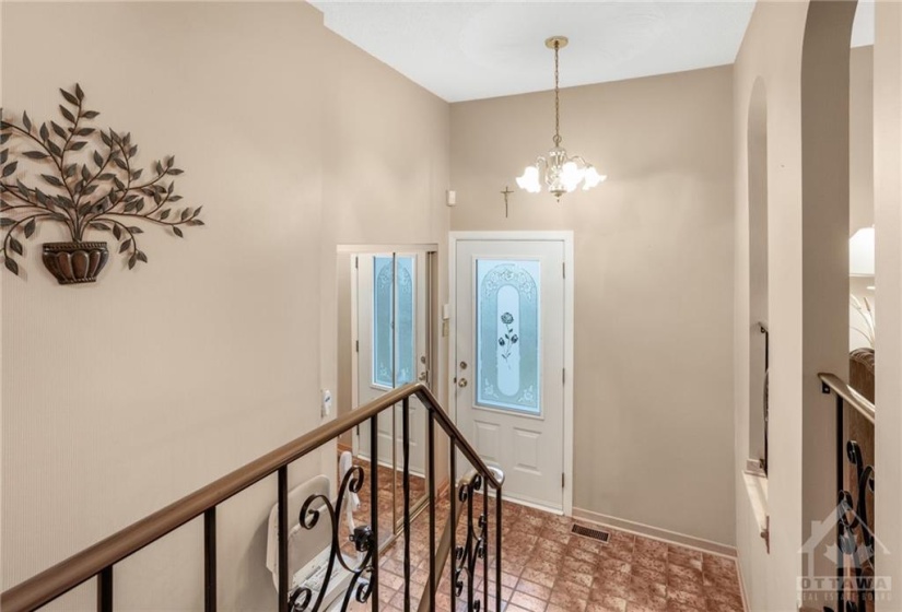 Front foyer with tile flooring & closet on landing boasting mirror doors.