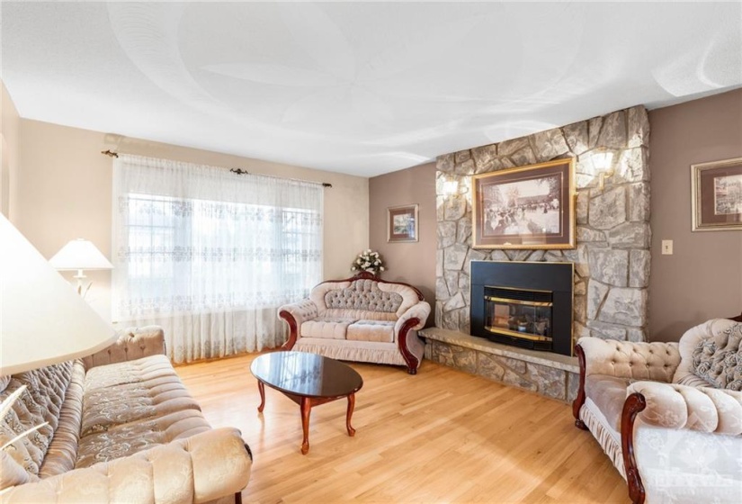 Spacious living room offering easy maintenance hardwood flooring and gas fireplace for those chillier evenings.