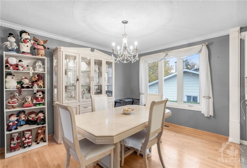 Bright, south facing eating area with the same quality flooring, crown molding and picture window.