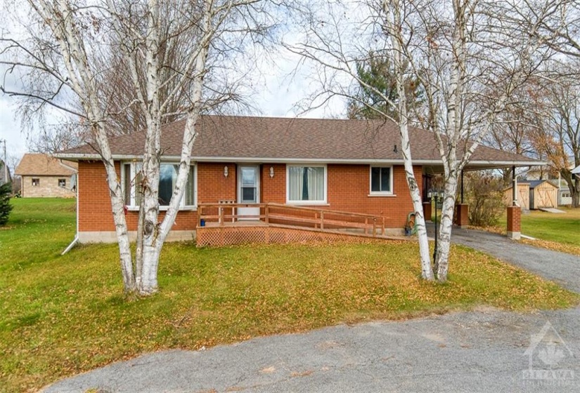 Front of the home, facing onto a large U-shaped driveway