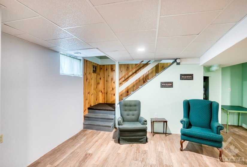 Stairs down to the lower level family room come from the carport entryway