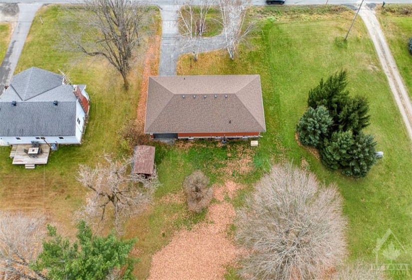 View of the property from above and behind. Large open backyard awaiting your vision