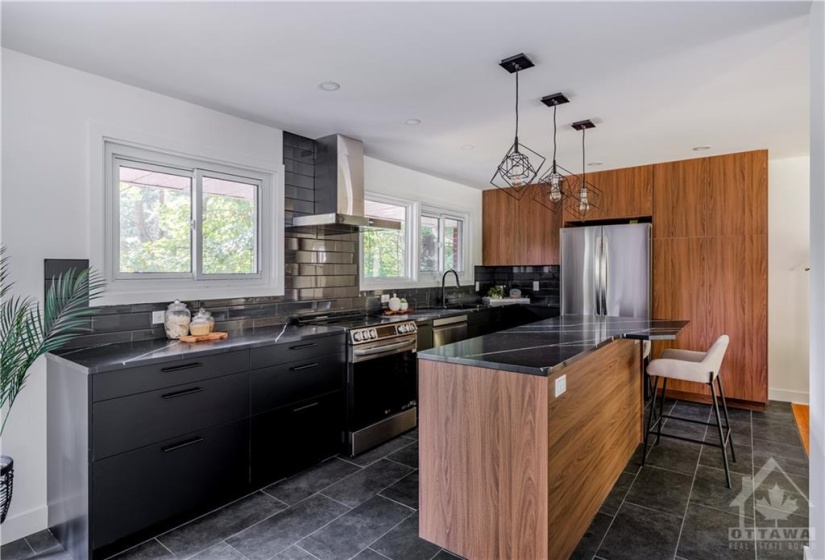 Bight Modern Kitchen with Beautiful Over Island Lighting, Modern Tile Back Splash, Quartz Counters, Large Windows - Perfect for Entertaining!