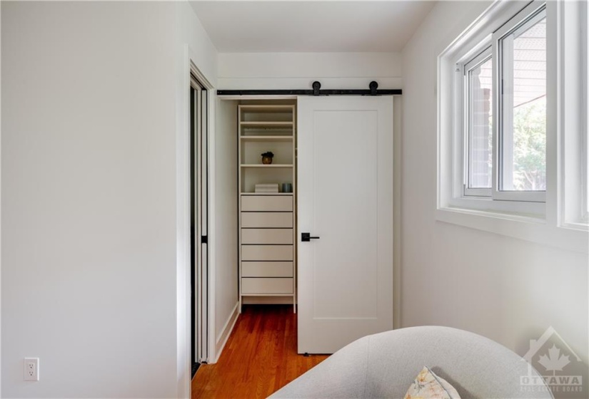 Charming Closet with Custom Shelving and Doors