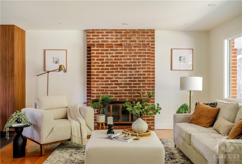 Straight View into Living Room - Beautiful Brick Wall with Wood Fireplace