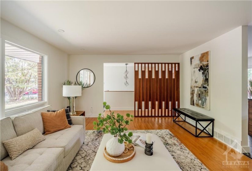 View of Living Room from Fireplace - Open Concept with Beautiful Accent Lights leading down Staircase to Basement