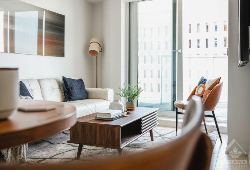 Living room, hardwood flooring. Entrance to outside terrace.