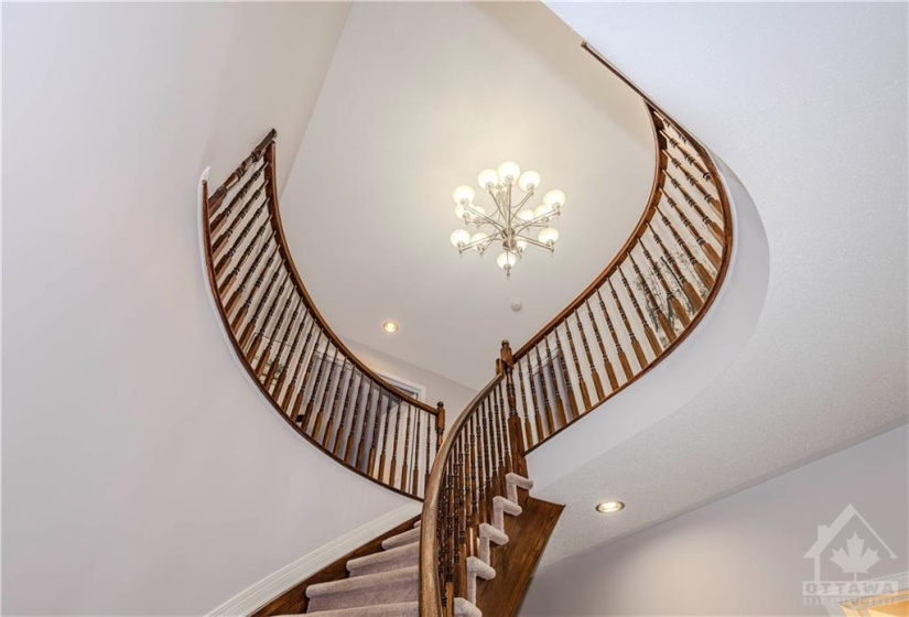 Grand curved staircase adds elegance